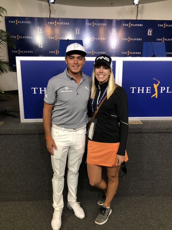Pernilla Lindberg, wearing a media credential, with Rickie Fowler in front of THE PLAYERS backdrop
