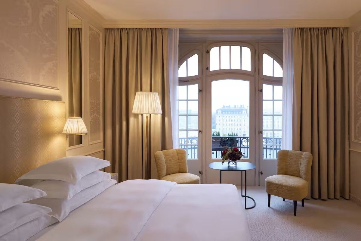 A guest room at Hotel Diplomat with tall windows onto the waterfront